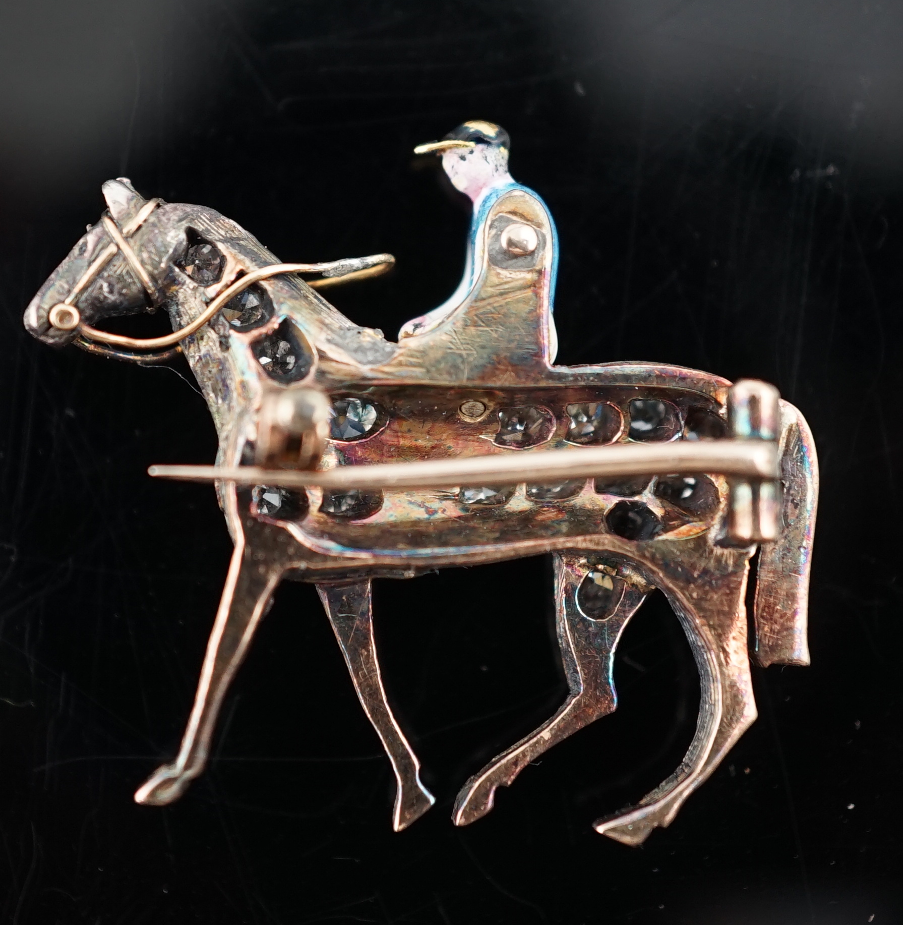 A late Victorian gold, rose cut diamond and polychrome enamel set horse and jockey brooch